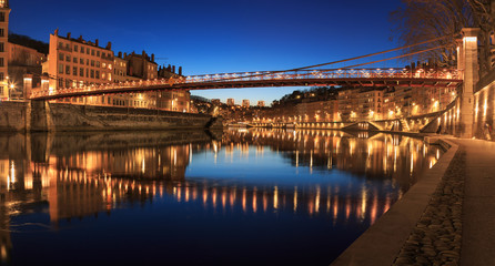 Fototapeta na wymiar Illuminated bridge, Passerelle Saint-Vincent, over the Saone river in Lyon, France.