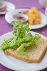 slices of whole grain bread and green oak lettuce