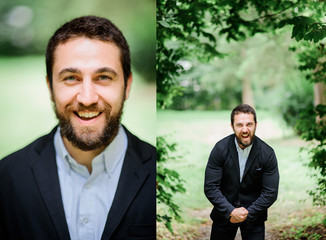 Sincere smile of bearded man with short hair standing in park