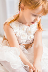Obraz na płótnie Canvas pretty little girl in a beautiful white dress