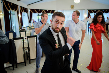 Groom looks funny dancing with friends