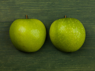 Fresh Ripe Apples on a Green Background