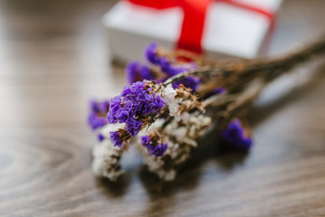 bouquet of wild flowers, a box with a red ribbon