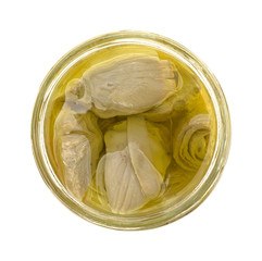 Marinated artichoke hearts in an opened jar top view isolated on a white background.