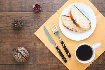 Sliced homemade bread with coffee on wood table