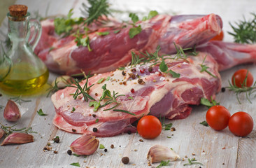 Fresh and raw meat. Leg of lamb on wood background
