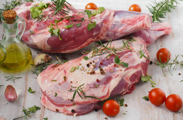 Fresh and raw meat. Leg of lamb on wood background