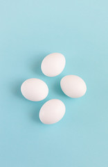 Easter decoration white eggs on a light blue background, minimal design with space for text, vertical image