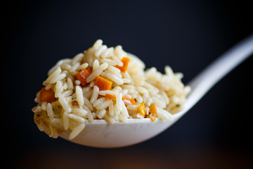 pilaf cooked in a large white spoon