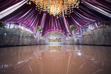 Glance path leads to wedding table for newlyweds standing under violet ceiling