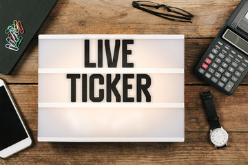 Live Ticker in vintage style light box on office deskt op