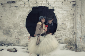 Love happy couple on a date on the ruins of an old building with a guitar