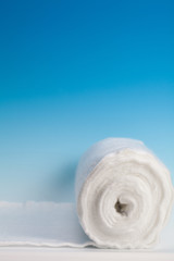 Obraz na płótnie Canvas Rolled cotton on blue background
