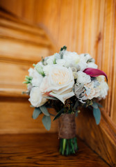Beautiful stylish wedding bouquet on the stairs