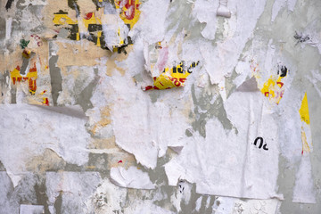 Colorful torn posters on grunge old walls, high resolution picture