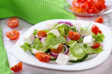 Fresh greek salad on white table