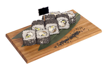 Sushi rolls on wooden Board with leaves of leeks and black sign for logo and name