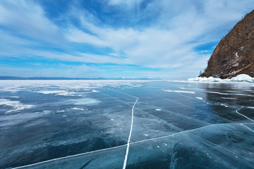 Frozen Lake Baikal. Beautiful clouds over the strait Small Sea (Maloe More)