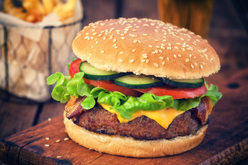 American Burger with bacon,cheese,tomato,lettuce,french fries and beer