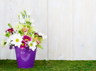 Flower arrangement on wooden background with space for your text