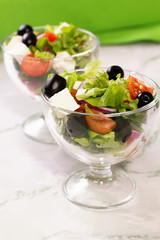 Fresh greek salad on white table
