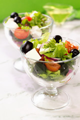 Fresh greek salad on white table