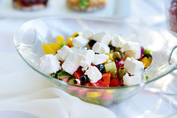 Delicious vegetables and goat cheese salad served on a party or wedding reception