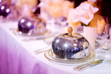 Beautiful table setting with crockery and flowers for a party, wedding reception or other festive event