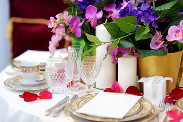 Beautiful table setting with crockery and flowers for a party, wedding reception or other festive event