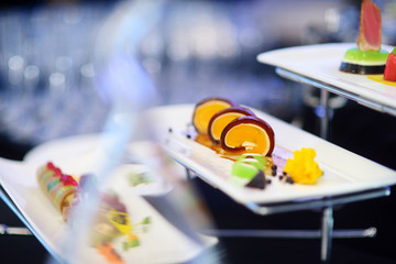 Molecular modern cuisine. Various fancy dishes on white plates in a restaurant.