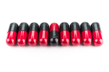 Black and red capsule pills