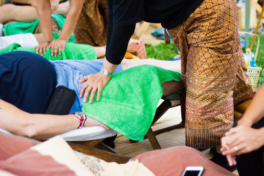 Thai woman making massage to a man -  Bangkok Thailand 