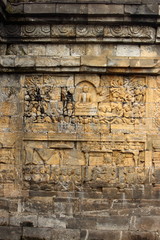 Fototapeta na wymiar Relief of Borobudur temple in Yogyakarta, Java, Indonesia/Borobudur temple stupas near Yogyakarta, Java, Indonesia