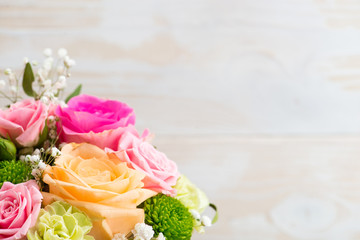 Flower arrangement on wooden background with space for your text