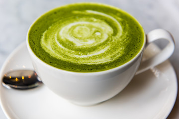 Hot green tea matcha latte in a cup