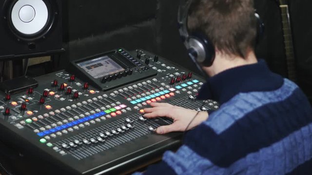 4k Sound designer working on the sound control, moving fader up and down