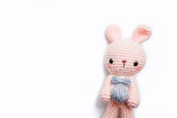 Rabbit crochet doll with yarn ball on white background