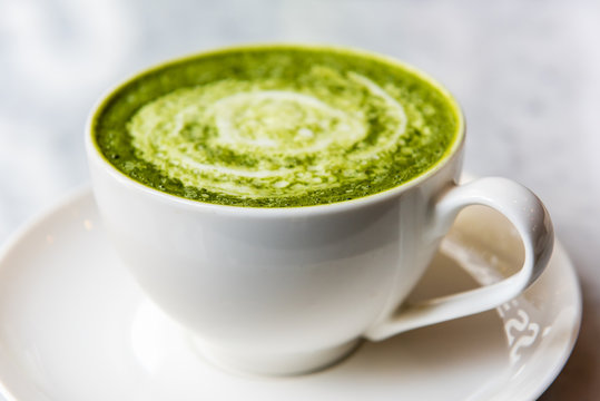 Hot green tea matcha latte in a cup
