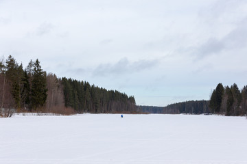 Frozen River and fisherman on ice