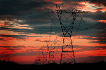 Power Lines for Electricity Metal Towers and Sunset