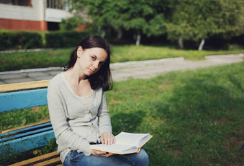 Obraz premium wonderful girl reading a book sitting in the park