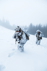 Winter arctic mountains warfare. Action in cold conditions. Pair of special forces weapons in...