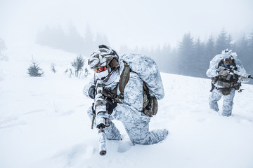 Winter arctic mountains warfare. Action in cold conditions. Pair of special forces weapons in...
