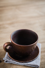 Empty Clay Cup on Wooden Background.