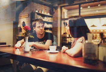 a man talking with his girlfriend in cafe