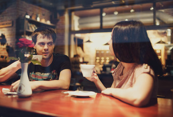 a young man talking with his girlfriend