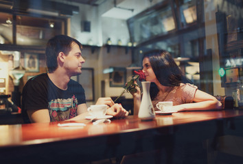 young man  and woman  talk in a cafe