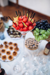The vase with watermelons stands on the banquet table