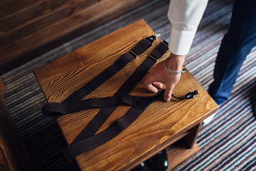 The groom keeps suspenders