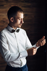 The fiance wears  cufflinks